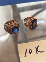 Overview of both rings side by side on reflective surface