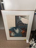 Full view of framed embossed print showing still life with teapot, cup, dove and clock motif