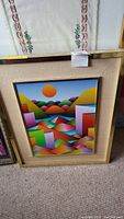 Front view of framed colorful geometric abstract landscape print