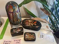 Group view of all boxes and metal stand on display surface