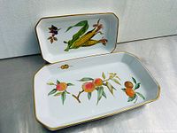 Two Royal Worcester Evesham trays showing full top view of botanical patterns with gold trim.