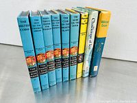 Spine view of 10 vintage paperback books mainly Hardy Boys and Nancy Drew series showing titles and condition