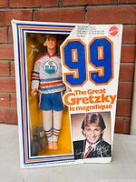 Full front view of the doll in original box showing Wayne Gretzky in hockey uniform, number 99 and branding on box.