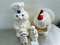 Front view of the vintage Pillsbury Doughboy cookie jar and Turkey jar, also showing the salt and pepper shakers in front.
