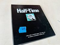 Front cover of a black binder labeled “Half-Time”
