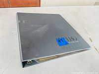 Closed grey 3-ring binder on table