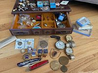 Jewelry box opened with contents displayed on and around it
