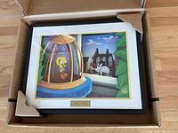 Front view of framed cel in original box showing Tweety in cage and Sylvester outside