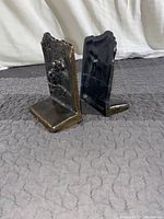 Pair of antique brass bookends, view from the back and side showing thickness and patina.