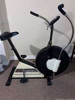 Side view of the full Johnson Accufit 2000 air bike showing seat, pedals, fan wheel, and handlebars.