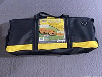 Photo of the black and yellow carrying bag with Franklin branding and product label showing 'Smooth Leggins' Cornhole set