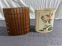 Photo showing front view of both decorative waste bins, highlighting wood pattern and floral design