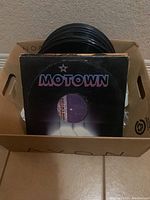 Box containing around 40 vinyl LP albums with a Motown album cover visible on top.