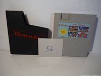 Nintendo grey cartridge labeled '115-in-1 Turbo Cartridge' with game screenshots on label alongside original black Nintendo cartridge sleeve.