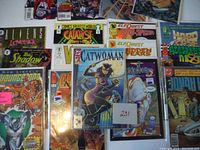Photo showing Catwoman #1 with embossed cover along with other comics such as Aliens vs. Predator, Catalyst, Elf Quest, Youngblood, The Shadow, Jonah Hex.