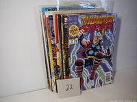 Stack of comic books with Thunderstrike front issue visible