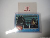 Front view of the Star Wars 1977 trading card showing Darth Vader and an officer.