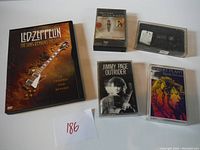 Lot contents: Led Zeppelin DVD and three cassette tapes of Jimmy Page and Robert Plant music