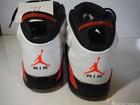 Back view of pair showing Jumpman logo and AIR text on heel with color pattern.