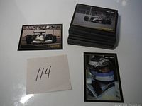 Pile of about 114 black-bordered Formula 1 race cards with one card featuring Lamborghini 291 on top and a driver image card next to the pile.