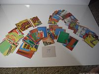 First photo shows a spread of colorful cartoon-style collectible cards from G.P. Kids and Wacky Packages, arranged in stacks with a handwritten '79' note