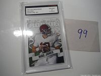 Front of Mac Jones rookie card in graded protective case showing player and card design