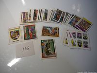 Spread of approximately 50 vintage Toxic High stickers displayed on a white surface with a paper marked '115'.