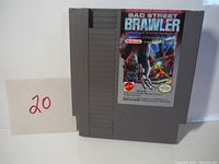 Front view of the grey NES cartridge showing the Bad Street Brawler game label with artwork and series branding.