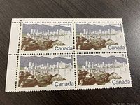 Front view of the plate block showing four $1 Canadian stamps featuring Vancouver cityscape with mountains.