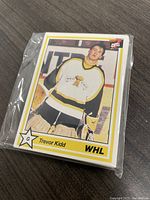 Single stack of sealed hockey cards featuring Trevor Kidd on front card.