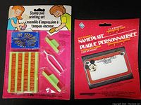 Full view of both items in original packaging, the name plate magnet on the right and the stamp pad printing set on the left.