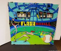 Front view of the Flash Baseball arcade glass panel showing colorful graphics and scoreboard windows.