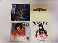 Front view of the four 45 RPM record sleeves showing album art for Skunk Anansie, Boston, Sheena Easton, and Jesse Johnson.