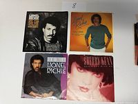 Front side of four picture sleeves for 45 RPM vinyl records featuring Lionel Richie and Sherry Kean, showing portraits and artwork