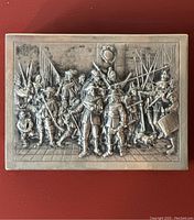 Top view showing detailed repousse scene of Renaissance soldiers with pikes and musical instruments on the cigarette box lid.