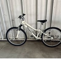 Side view of the white Specialized Hotrock mountain bike showing frame, wheels and overall condition.