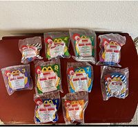 Front view of nine Marvel McDonald's superhero toys in sealed plastic bags with character and McDonald's logos visible.