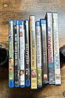 Photo showing DVD and Blu-ray cases including titles such as Brother Bear, Hereafter, The Blind Side, Made of Honor, and more.