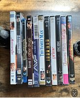 Photo showing 10 DVD movies including Family Man, Spider-Man, The Tuxedo, Armageddon, Uptown Girls, P.S. I Love You among others.