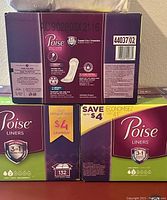 Photo showing three full boxes of Poise Liners, purple and green packaging, 132 liners per box, very light absorbency