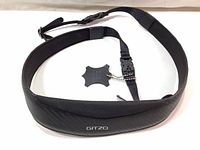 Full view of black Gitzo leather camera neck and shoulder strap with padding and adjustable buckle.