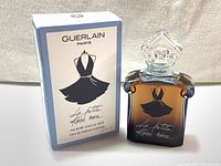 Front view of the boxed perfume showing the Guerlain Paris La Petite Robe Noire branding and bottle silhouette.