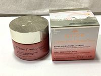 Photo of closed jar placed next to product box showing the packaging and branding.