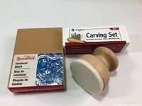 Photo showing Speedball linoleum block, Heritage carving set box, and handheld print baren with felt bottom.