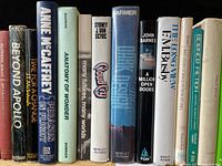 Row of 23 vintage science fiction books showing variety of titles and authors