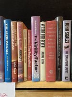 Shelf view of assorted vintage sci-fi books showing titles including The Sardonyx Net, Sex and the High Command, The Telepathist, The Butterfly Factor, Vector for Seven, among others.