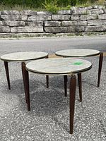 Three round nesting tables assembled on pavement