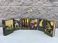Front view of 6 German Karl May classic hardcover books showing vintage graphic covers with various illustrated scenes