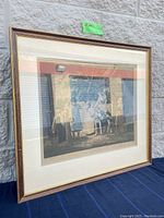 Full view of framed engraving angled against a wall showing vintage frame and overall artwork.