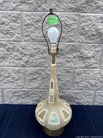 Full view of the Mid-Century Modern ceramic table lamp with bulb and metal fixture, showing height and shape.